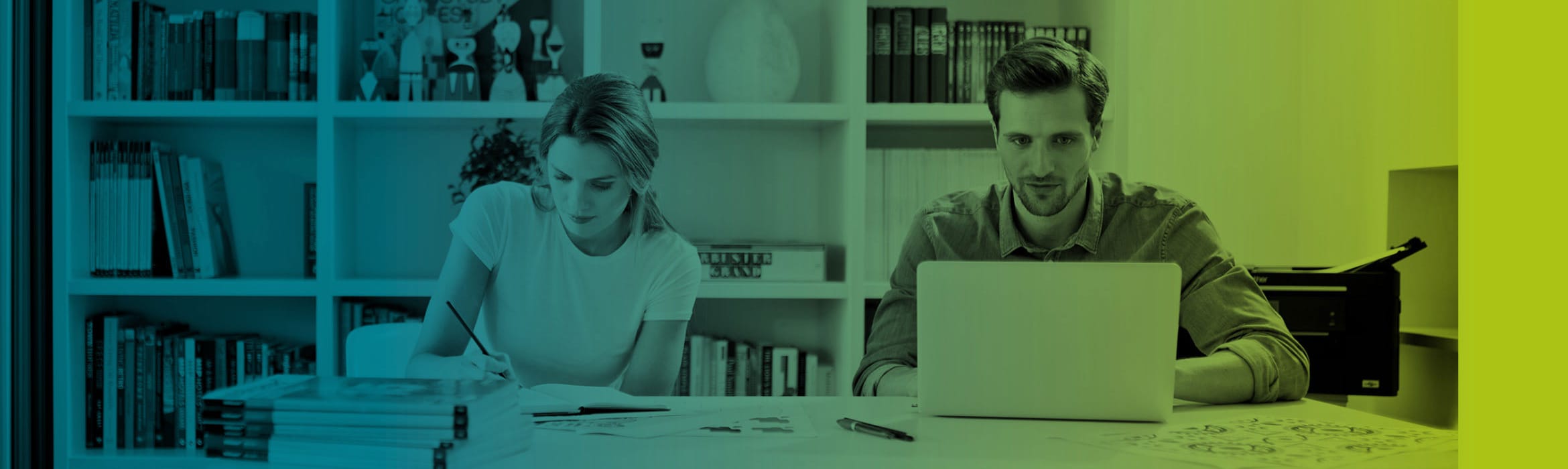 Blue to green gradient over a woman writing on a notepad and a man using a notebook computer while sat at a desk in front of a bookshelf