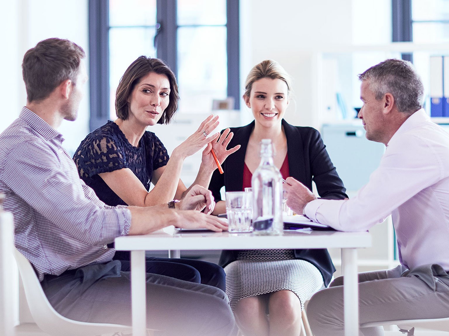 Group of colleagues chatting around a table
