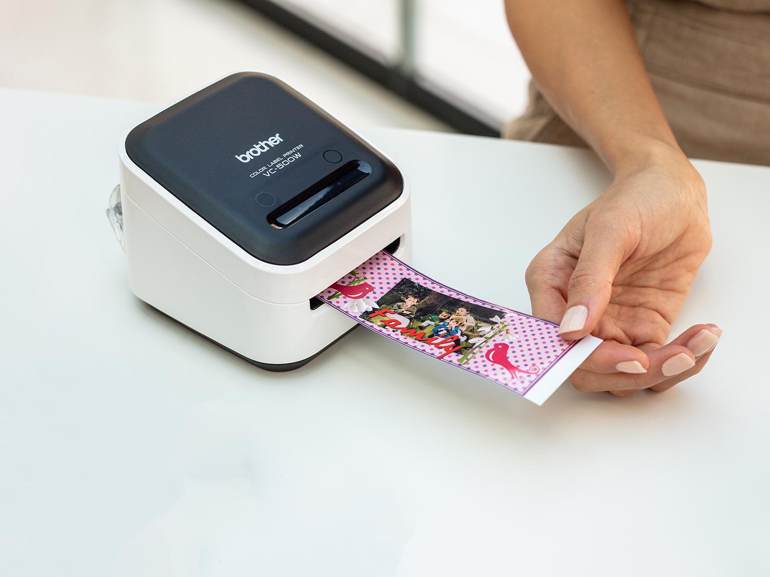 Brother colour label printer printing a wide label including clip art and photograph
