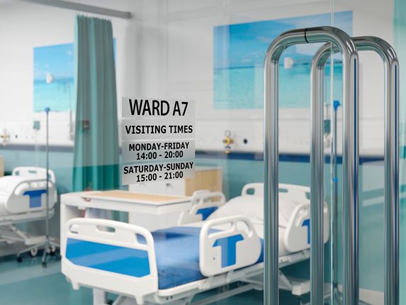 P-touch black on clear TZe labels on glass door for facilities management showing times of hospital ward opening 