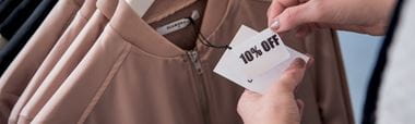 10% off mark-down label being applied to clothing