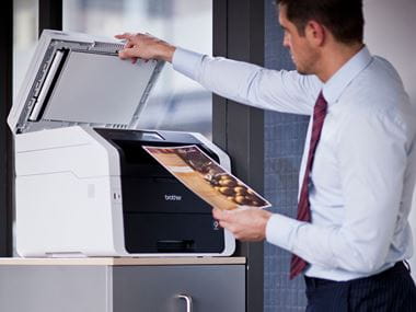Man using a Brother printer in the office
