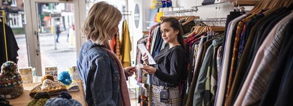 Two women interacting in a fashion retailer 