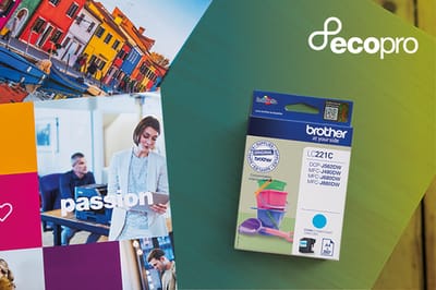 Brother ink cartridge carton on tabletop alongside colour prints