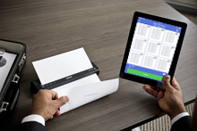 Man with iPad printing to brother mobile printer wirelessly