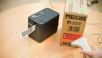 Mobile label printer on a table printing barcode from handheld scanner