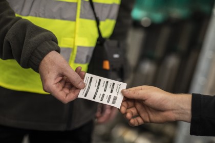 A field worker handing across a piece of paper printed on his RJ 3200 portable printer 