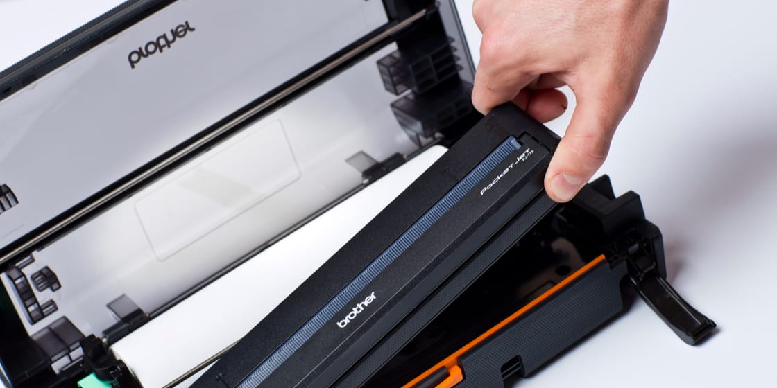 Person installing a print cartridge into a Brother PJ-762 mobile document printer