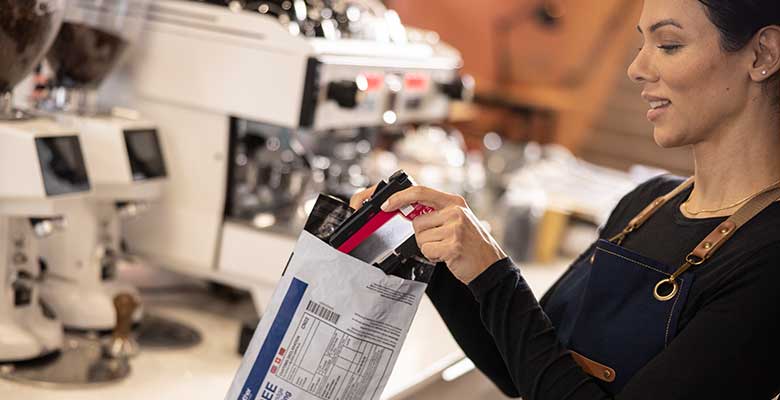 Female puttinh ink cartridge into bag