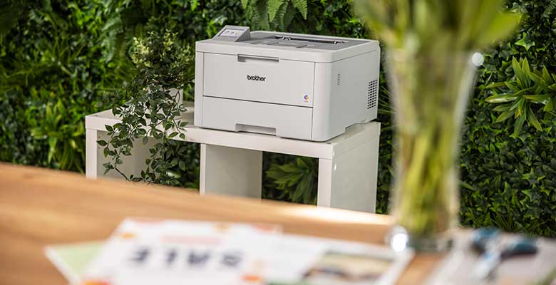 Printer in background with documents on table