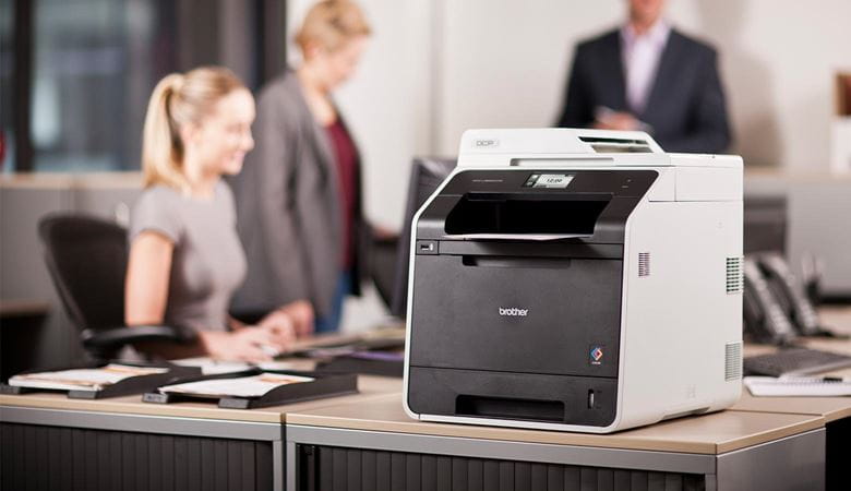 A Brother laser printer being used in an office