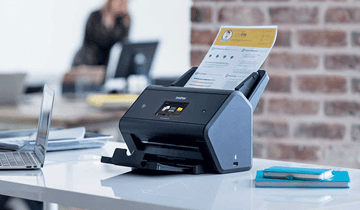 Brother scanner on a desk in an office environment