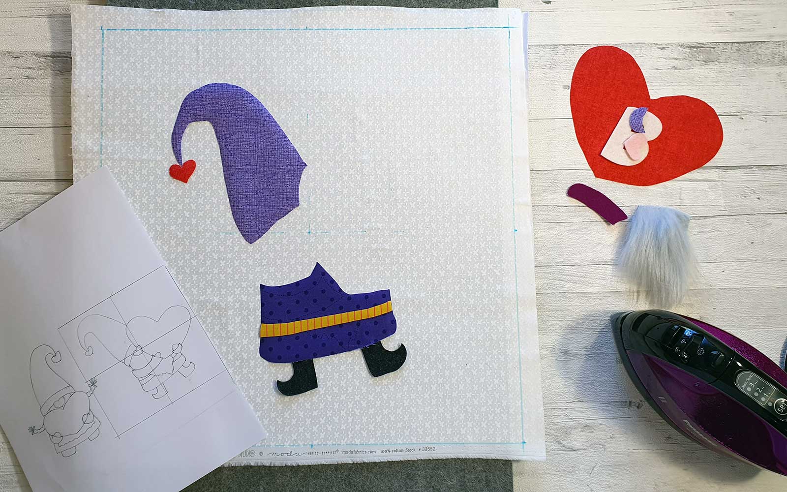 Half placed gnome fabric pieces with iron and diagram