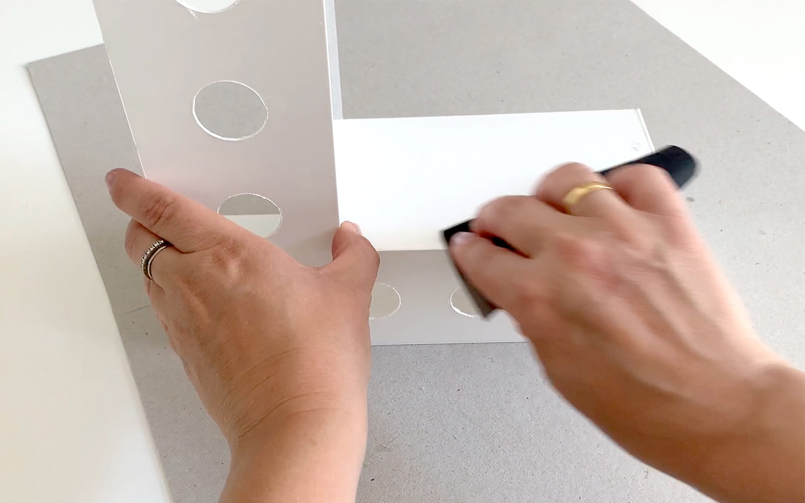 hand sanding edges of white 3D shaped polystyrene letter L
