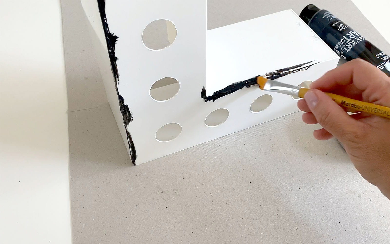 hand painting edges of white 3D shaped polystyrene letter L black