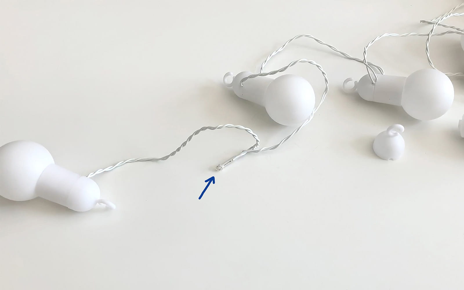 string of white bulb lights with one bulb removed