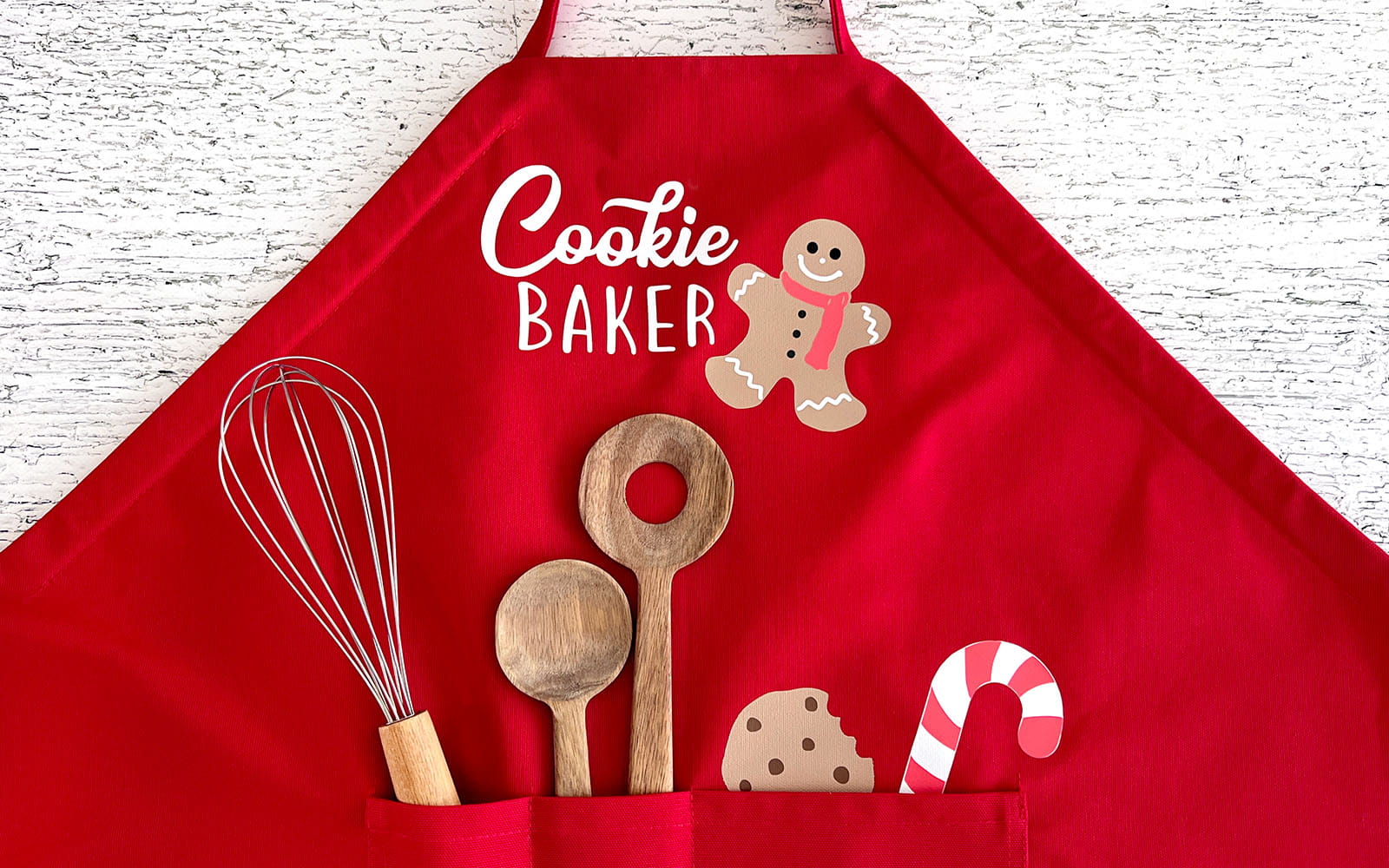 Red apron with baking utensils in pocket