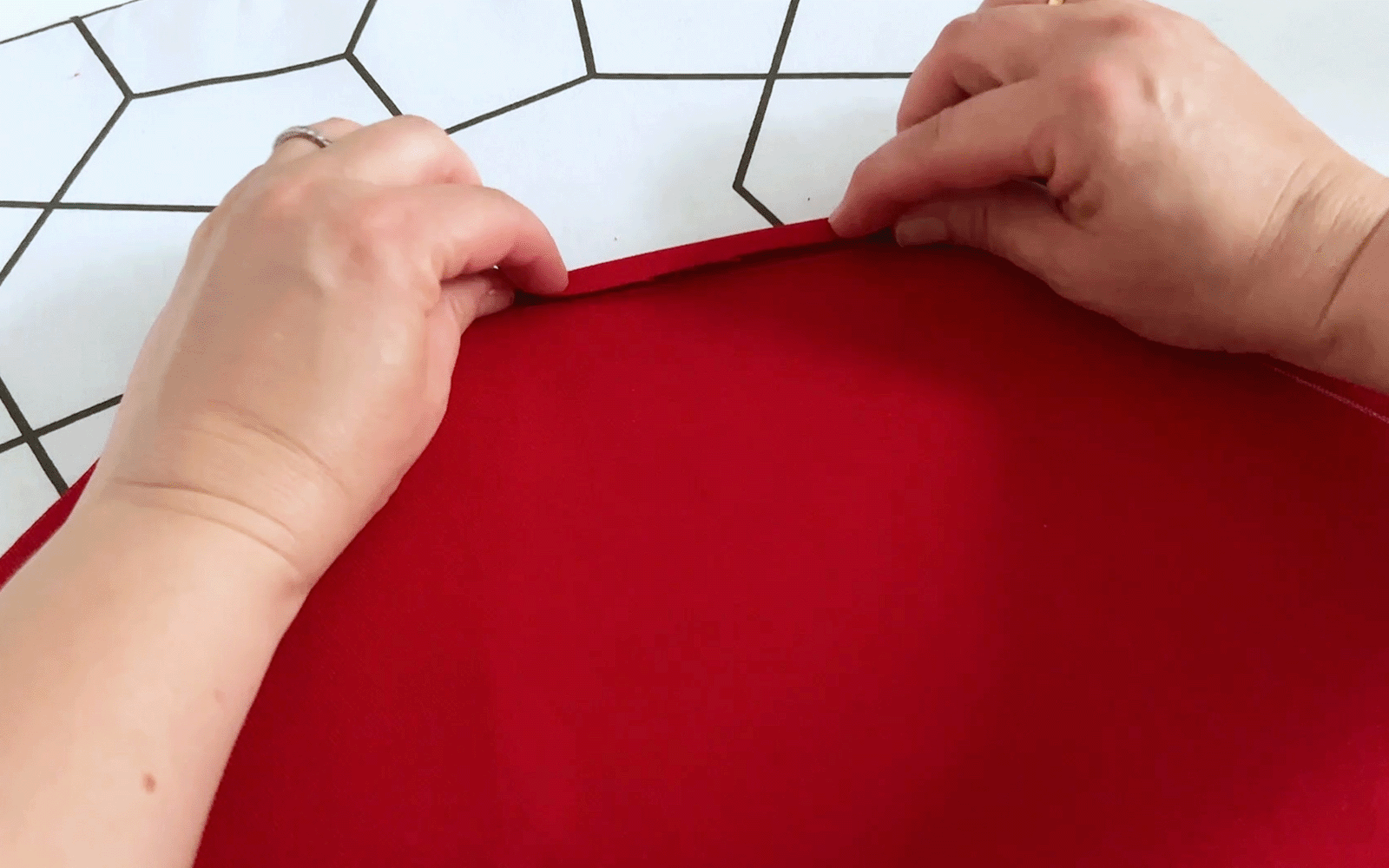 Folding red fabric and iron