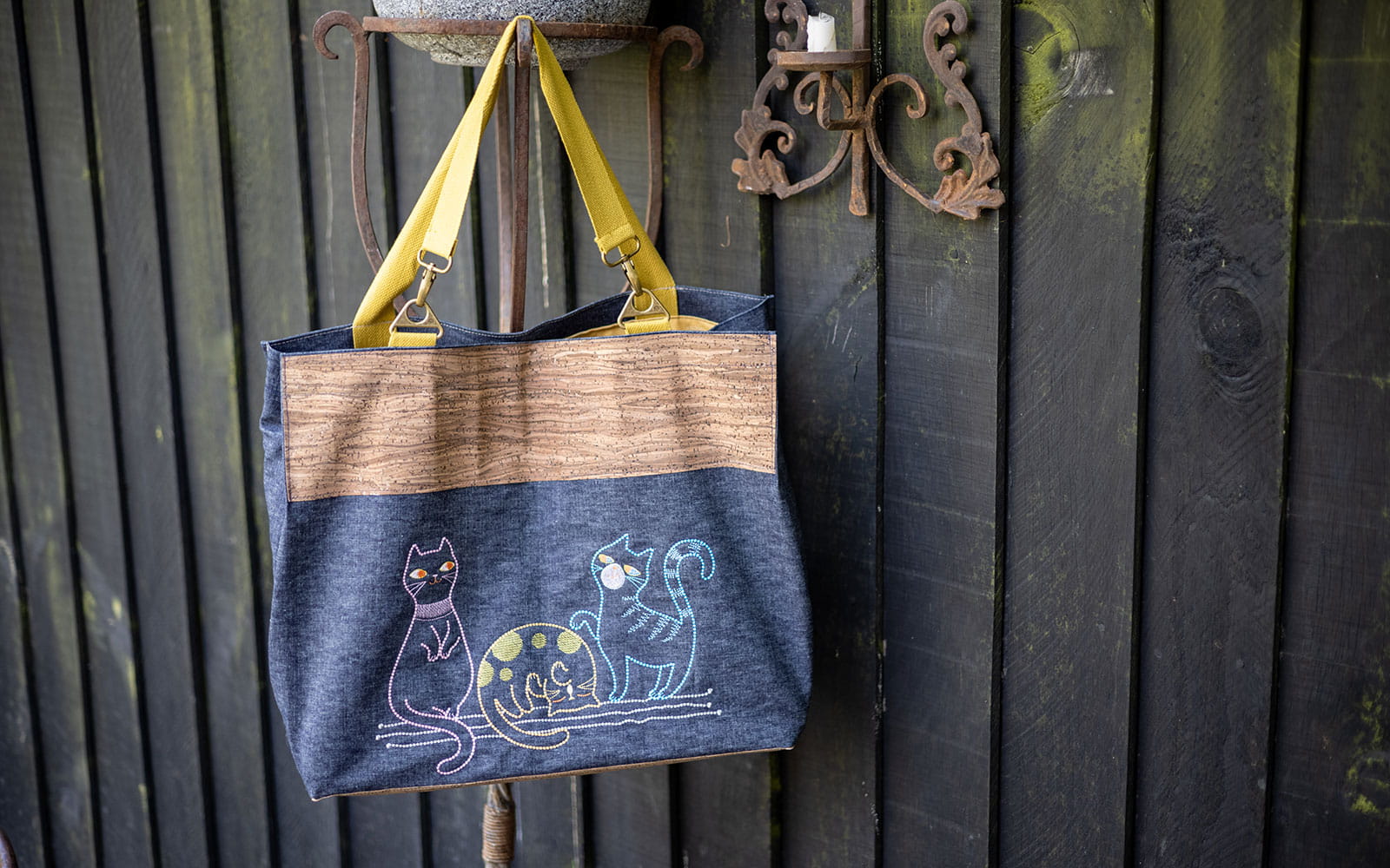 cork and denim bag with three cartoon cats embroidered on