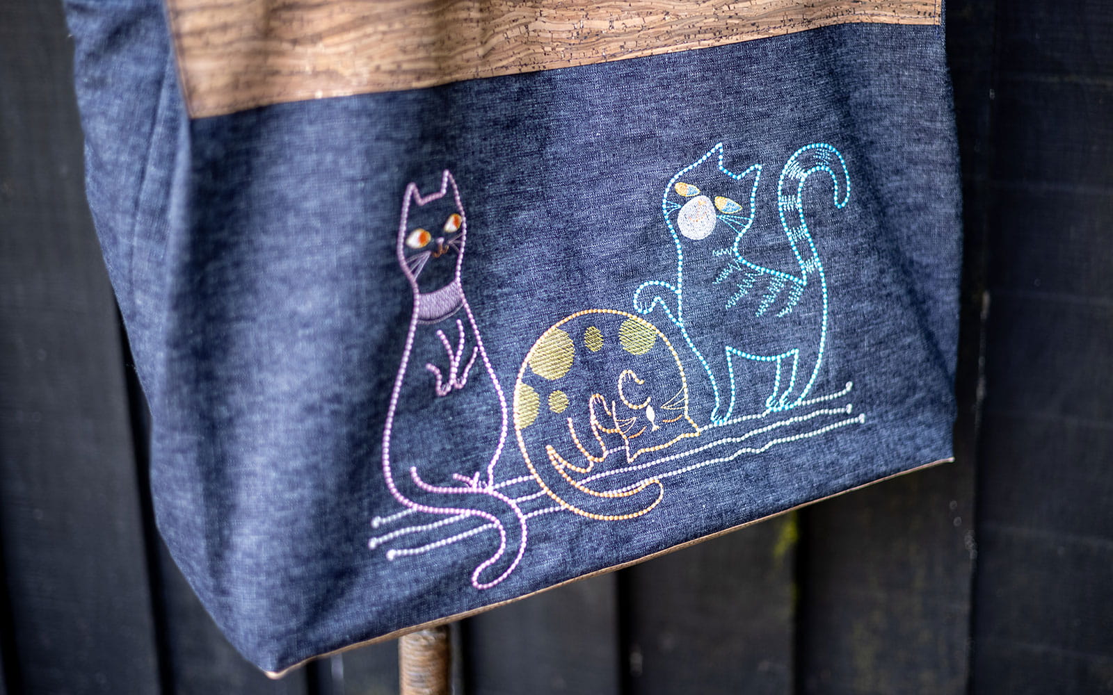 cork and denim bag with three cartoon cats embroidered on