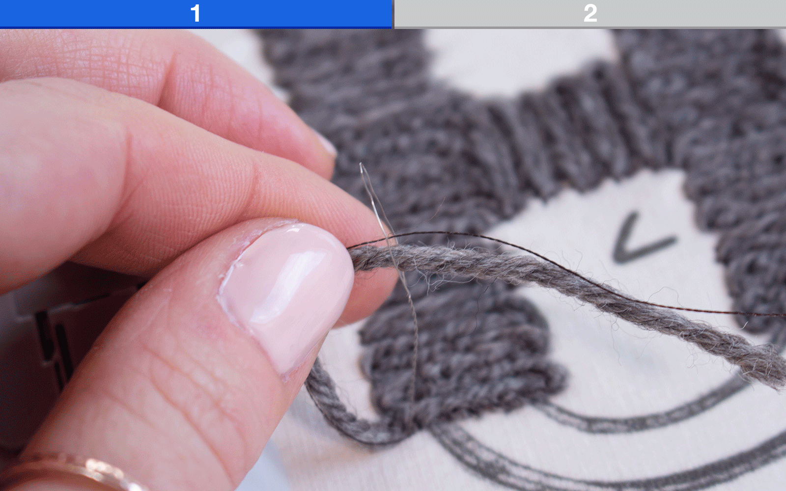 Yarn threaded into needle and interfacing on back of embroidery