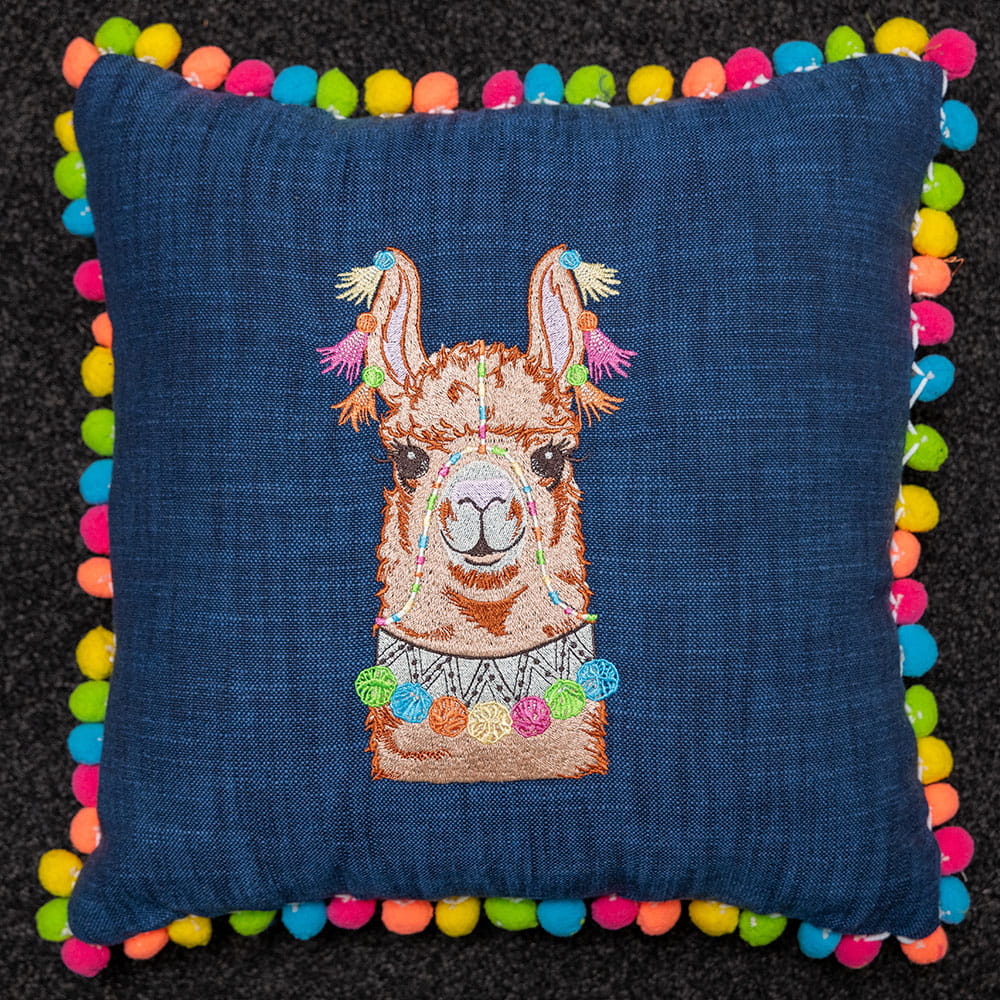 blue embroidered llama face embroideries with multi-coloured pompoms