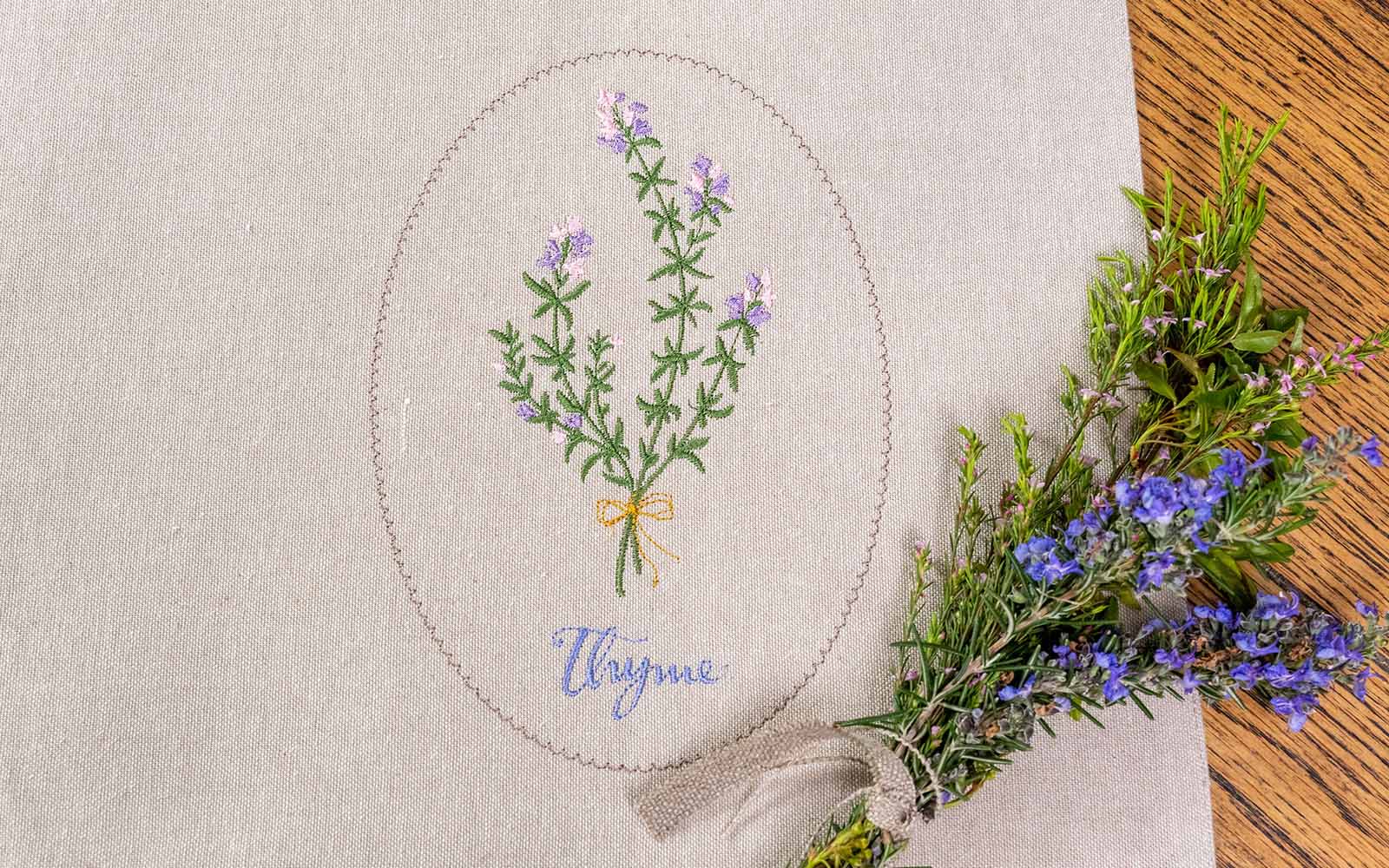 beige linen placemat with embroidered thyme motif