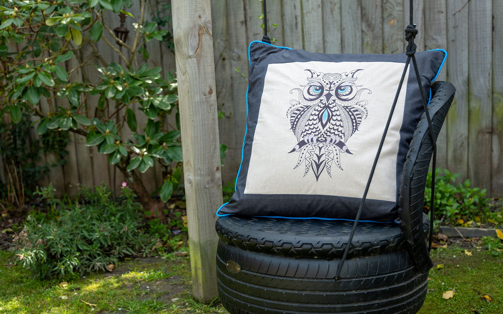 zentangle owl cushion on tyre swing in garden