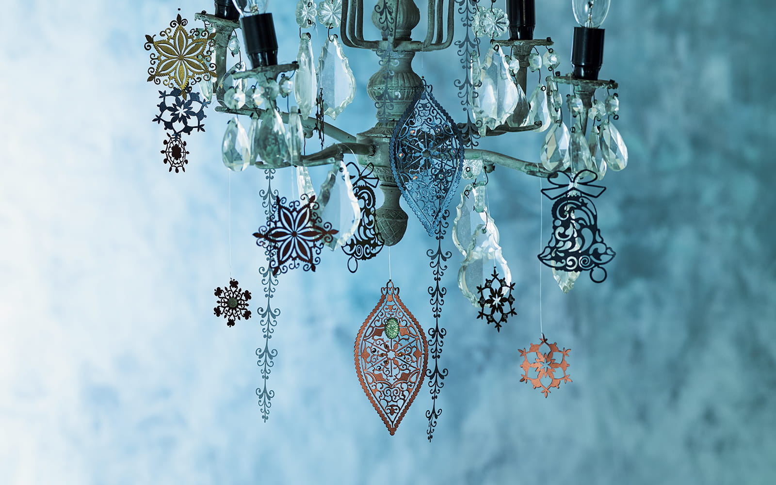 Chandelier with intricate tattered lace designs on blue background