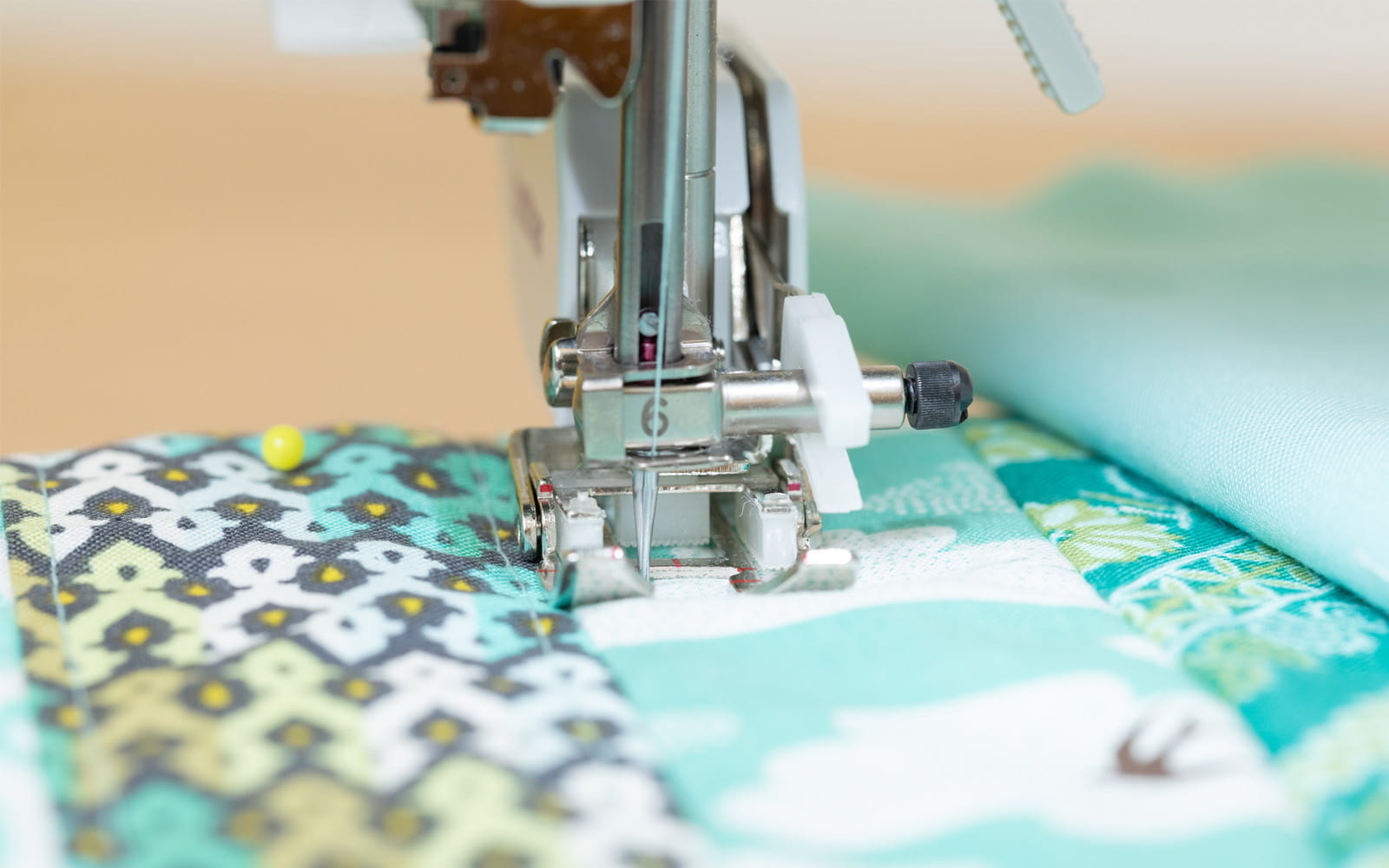 close up of Brother J sewing foot on green pattern fabric