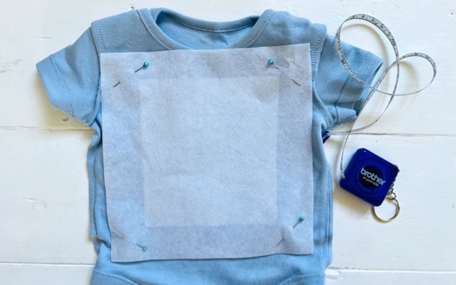 Blue babygrow with stabiliser pinned to it