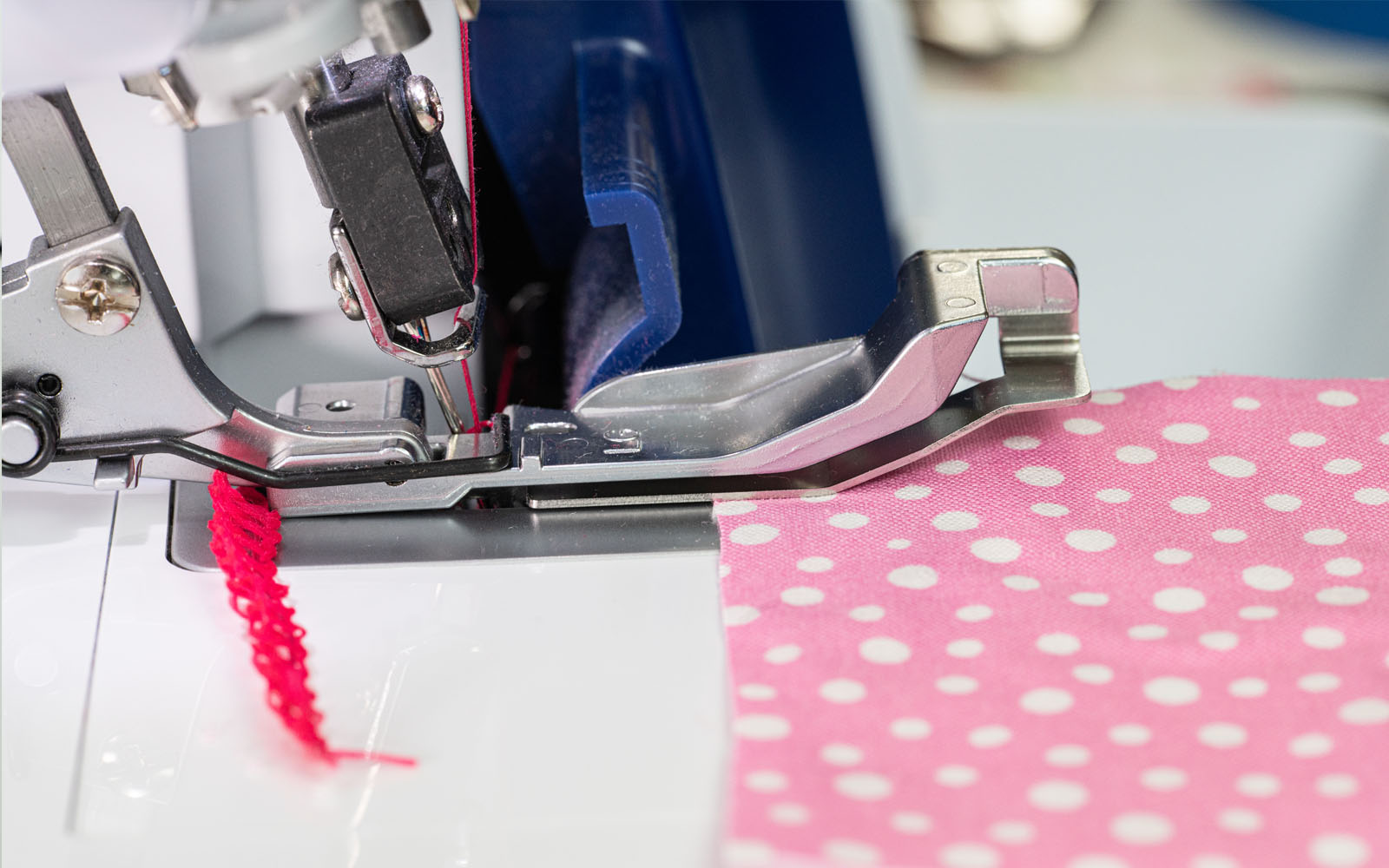 Pink fabric under ruffler foot on white overlocker