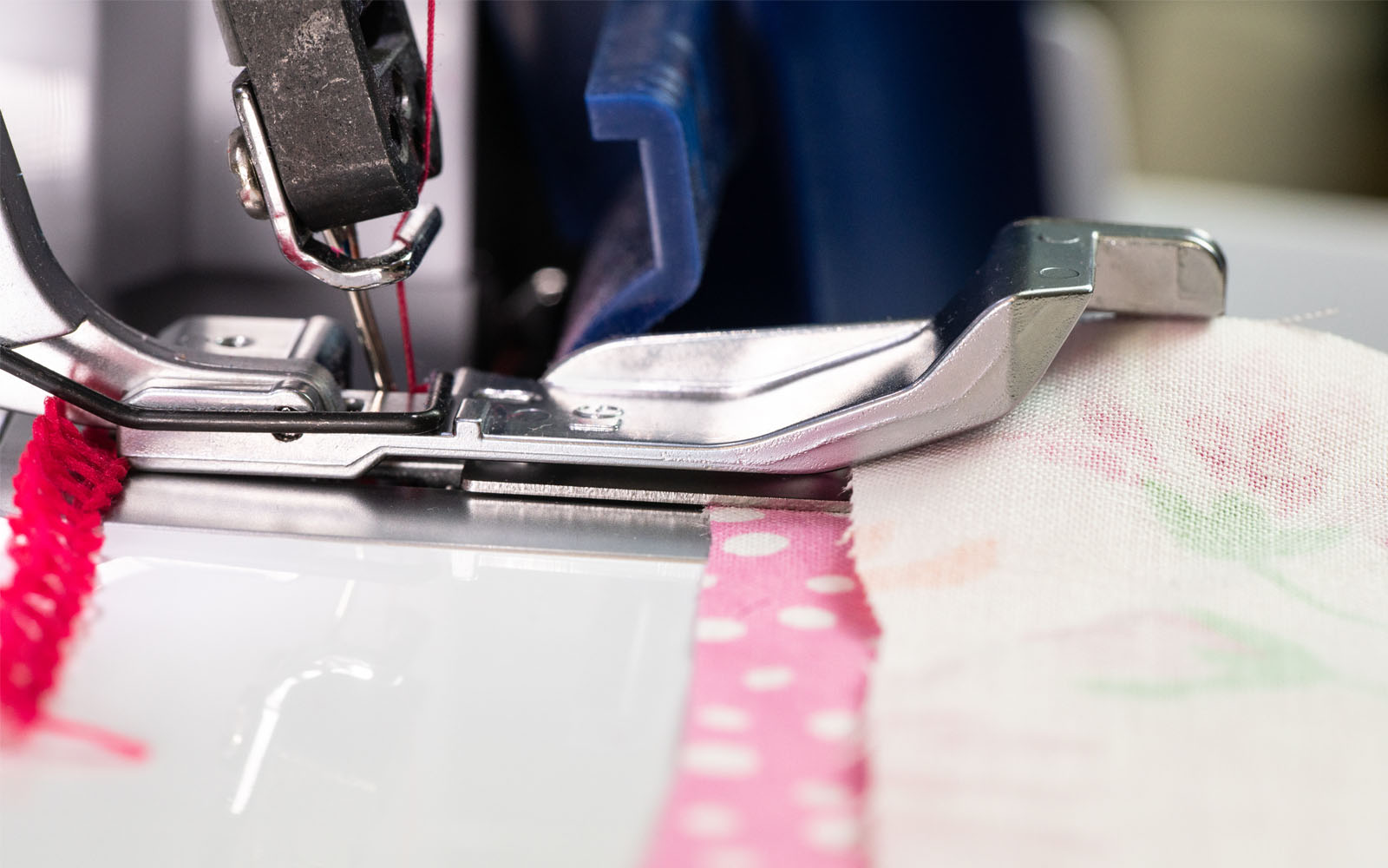 Pink fabric and floral fabric on overlocker