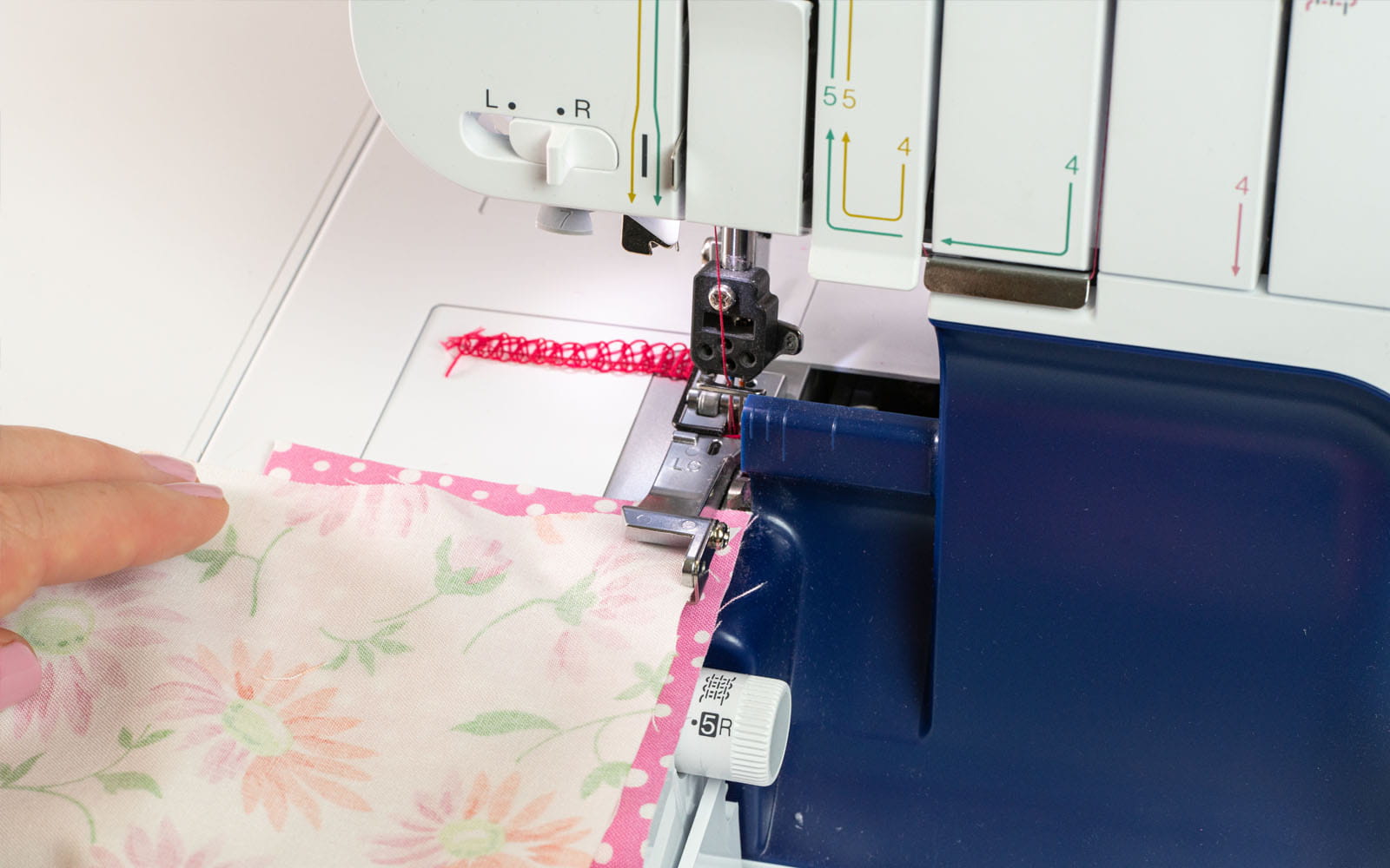 Pink fabric and floral fabric on overlocker