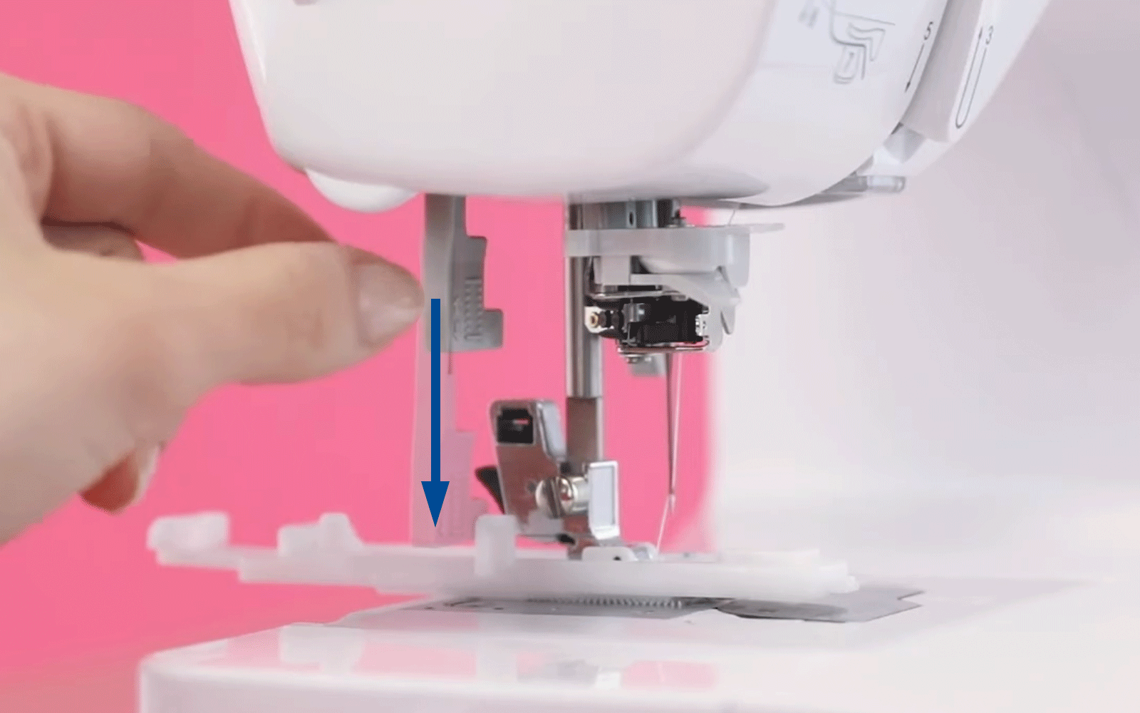 Hand pulling small grey lever down on Brother sewing machine