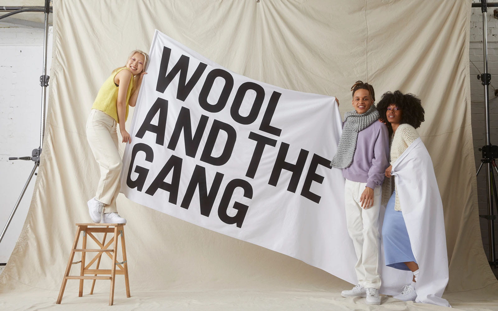 models in photo studio holding white banner