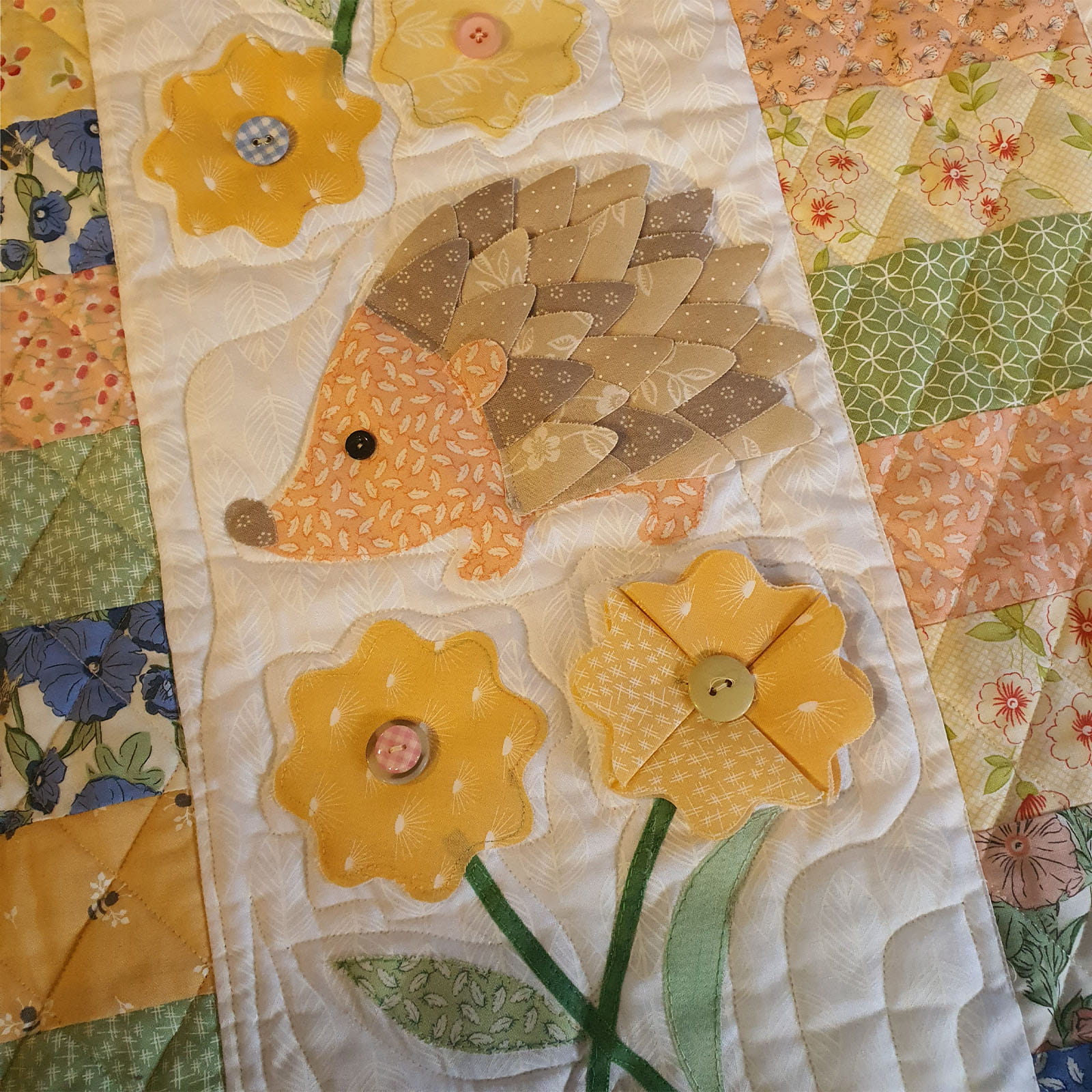 3D brown fabric hedgehog on quilt background