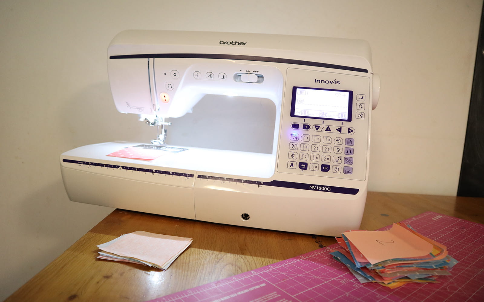 Brother NV1800Q sewing machine on table with square fabric stack