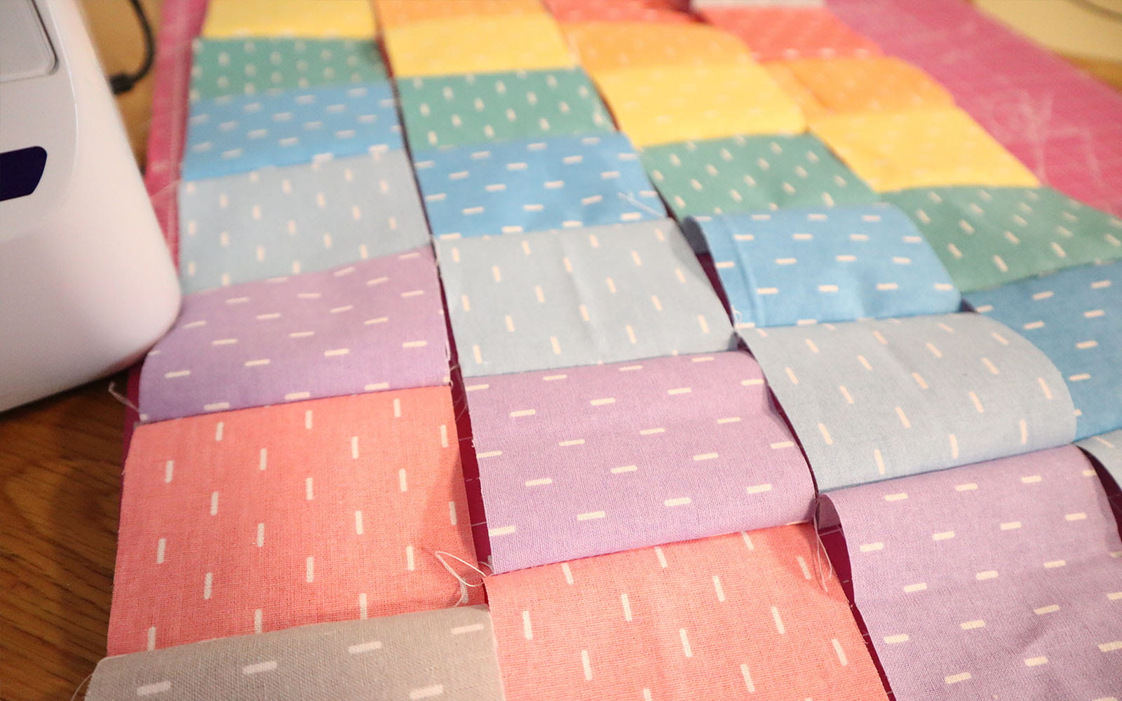 4 strips of alternating coloured fabric squares