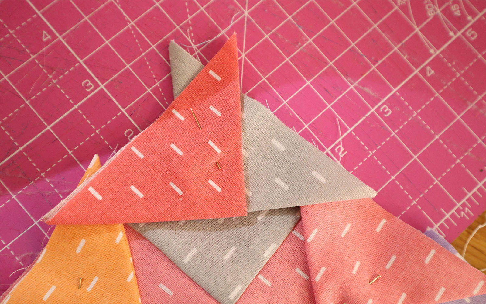 Triangles pinned to corner of fabric