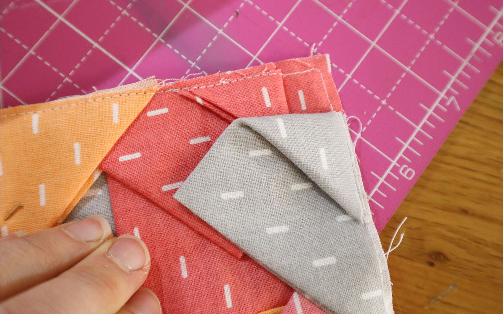 Result of sewn corner of triangle pieces on pink mat