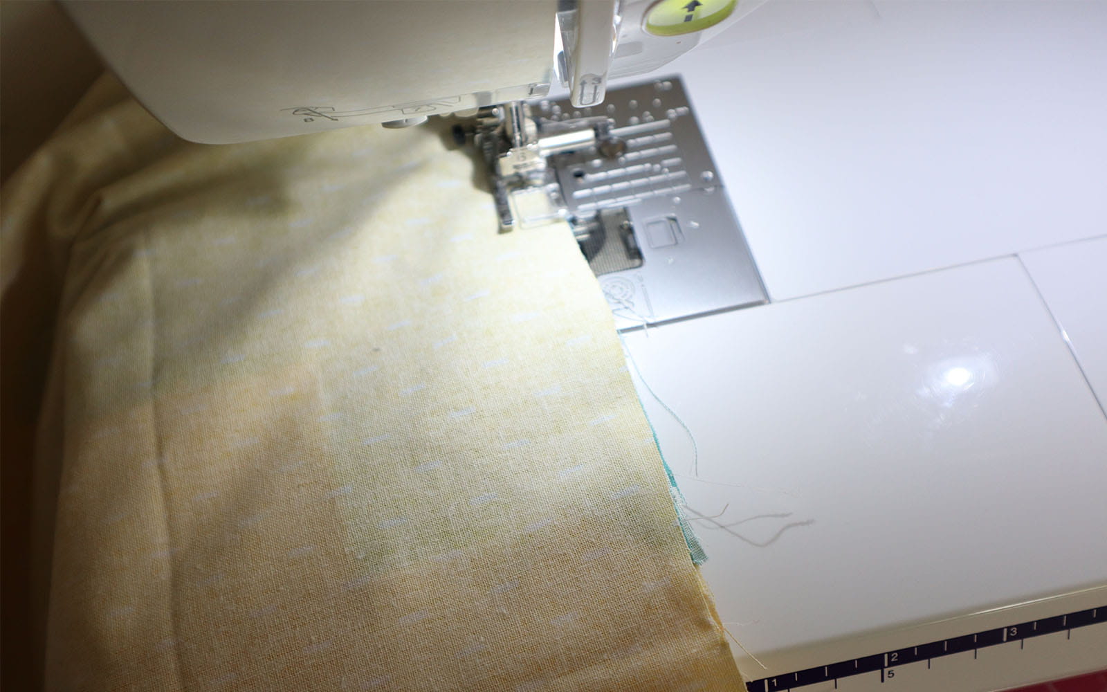 Fabric pieces being sewn together with sewing machine