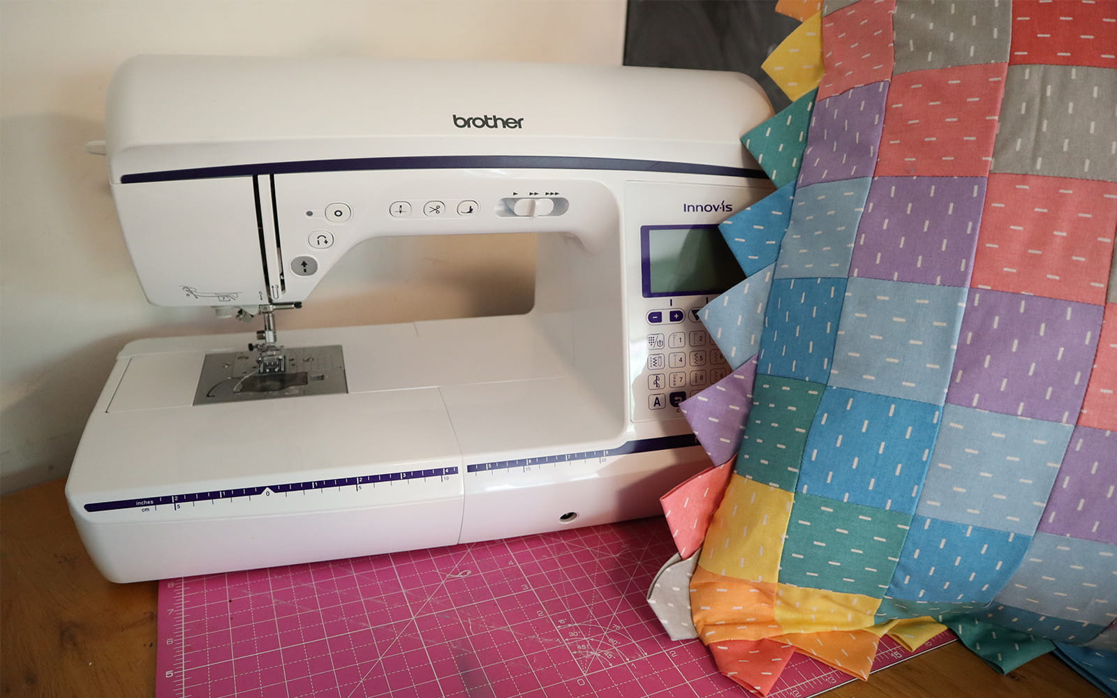 Multi-coloured cushion next to Brother NV1800Q sewing machine