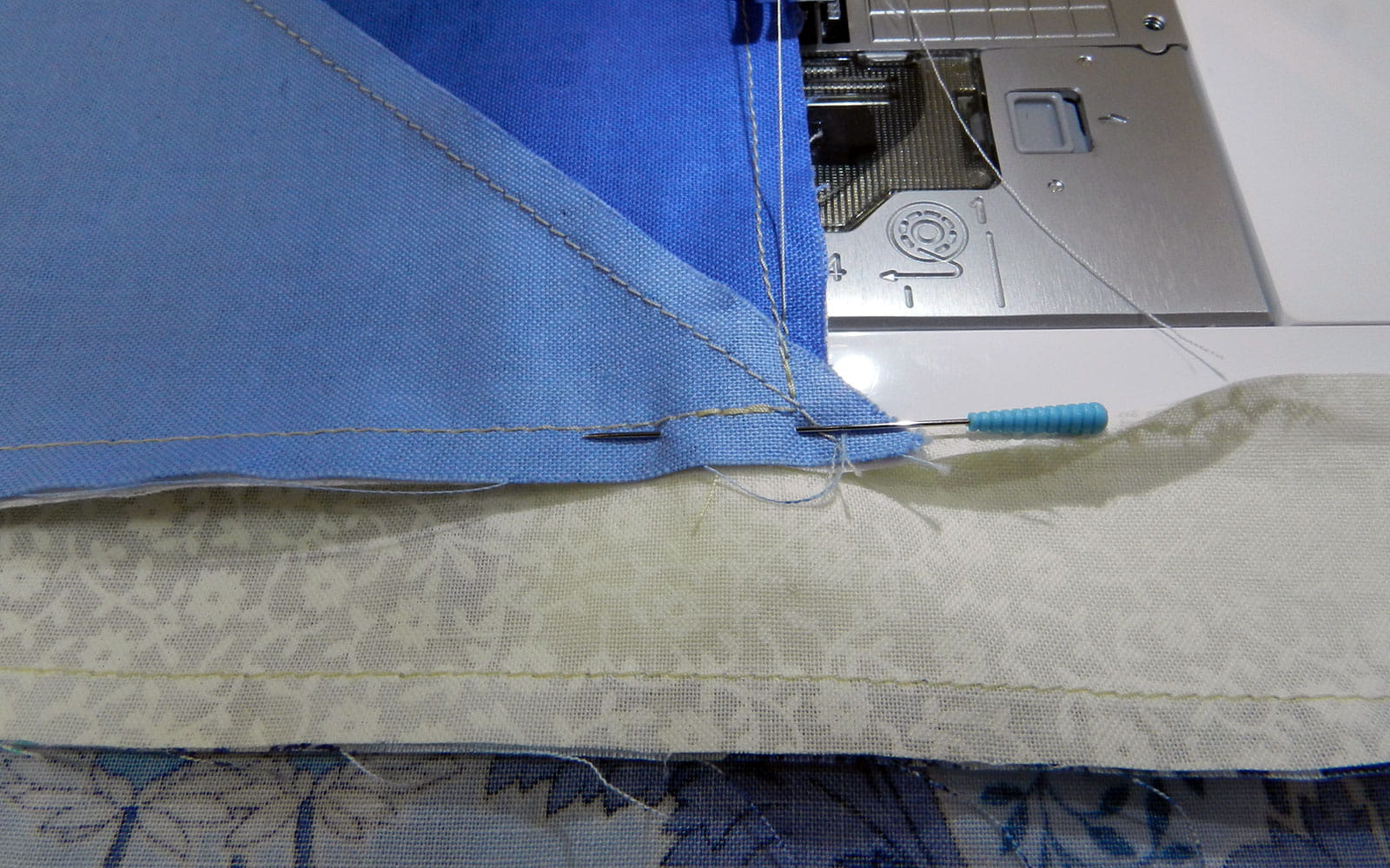 quilt corner with needle on sewing machine