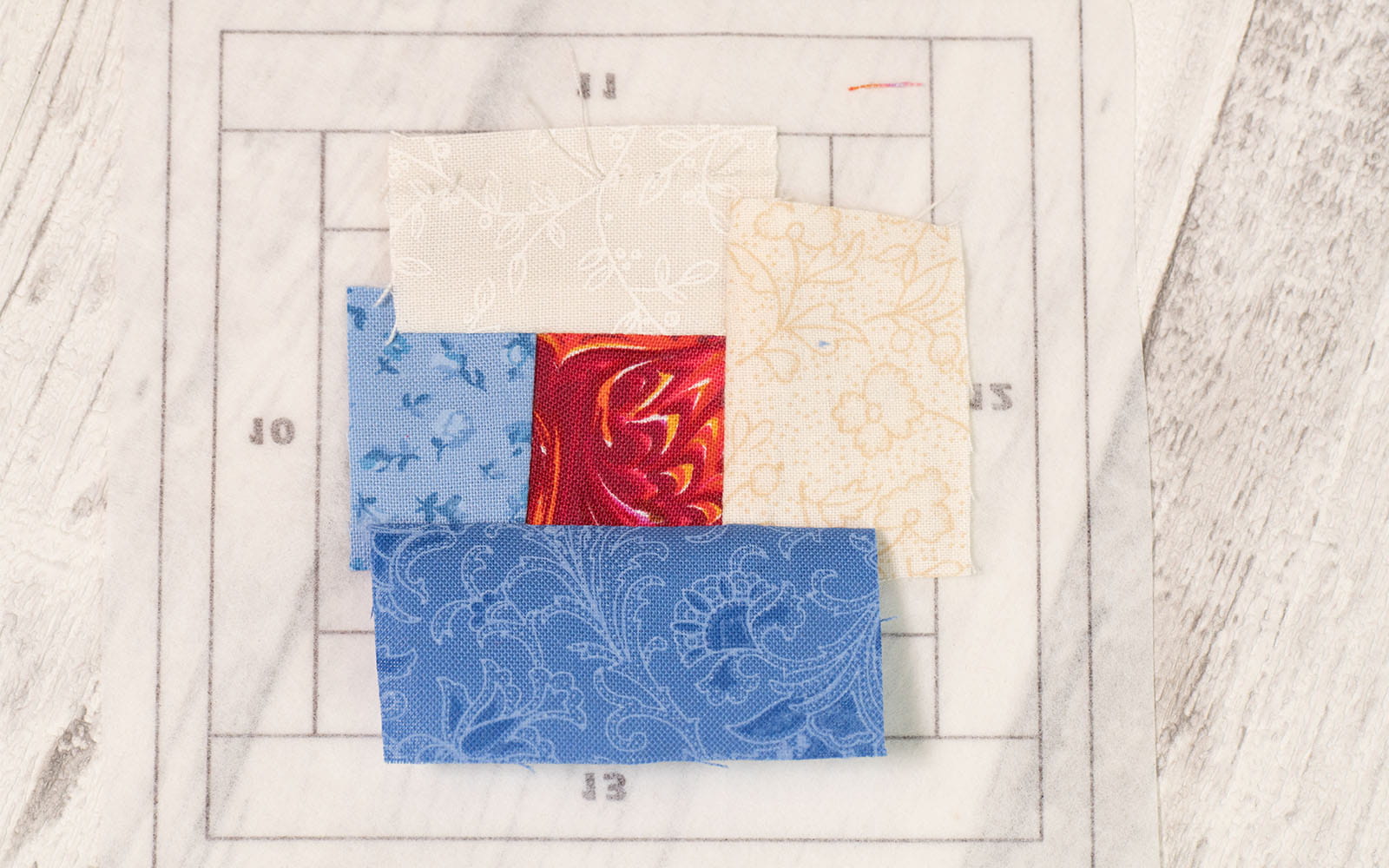 Fabric pieces place on paper piecing pattern