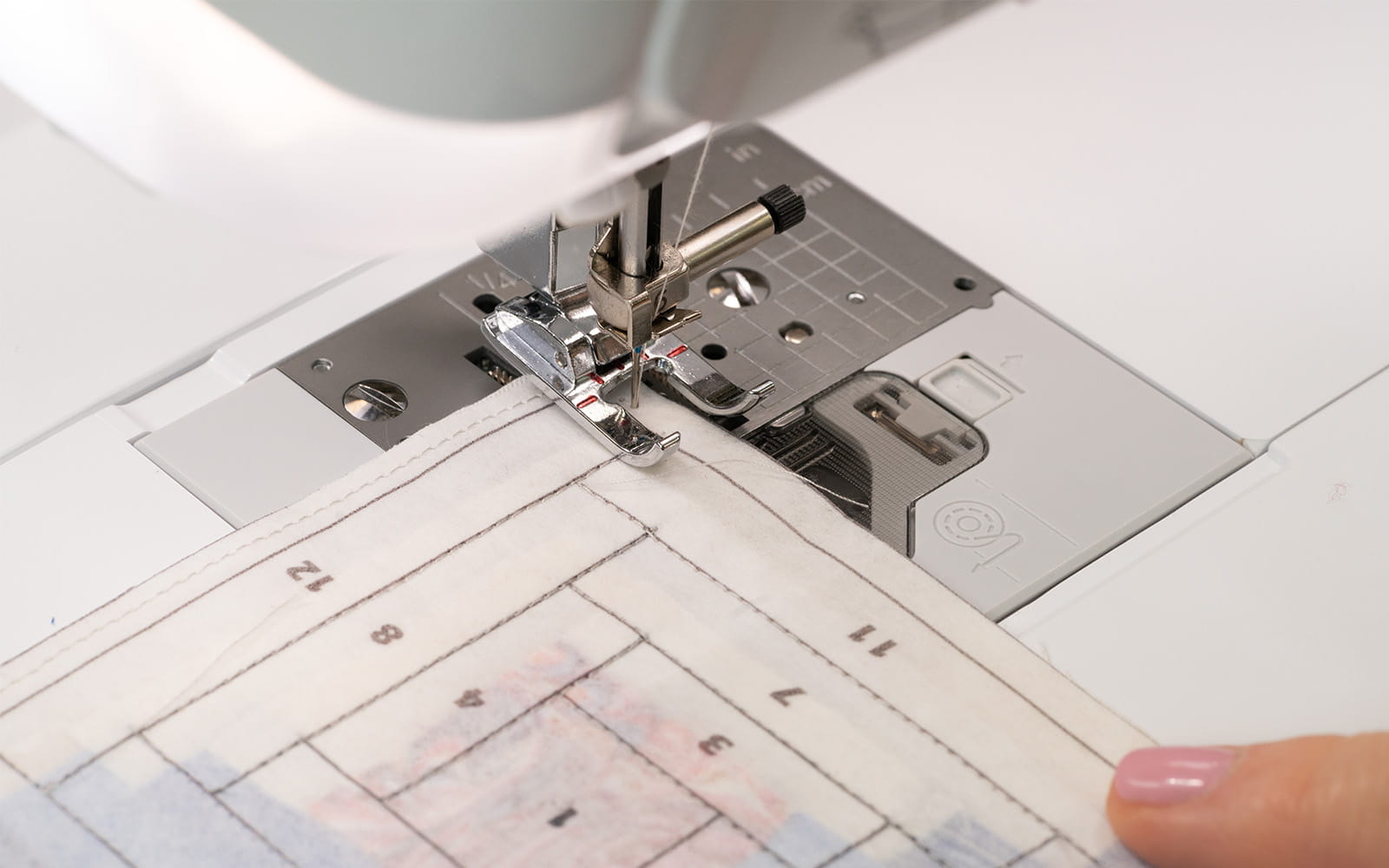 Sewing machine sewing on printed pattern