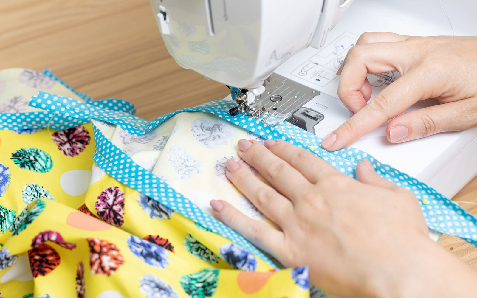 woman sewing blue bias binding on sewing machine
