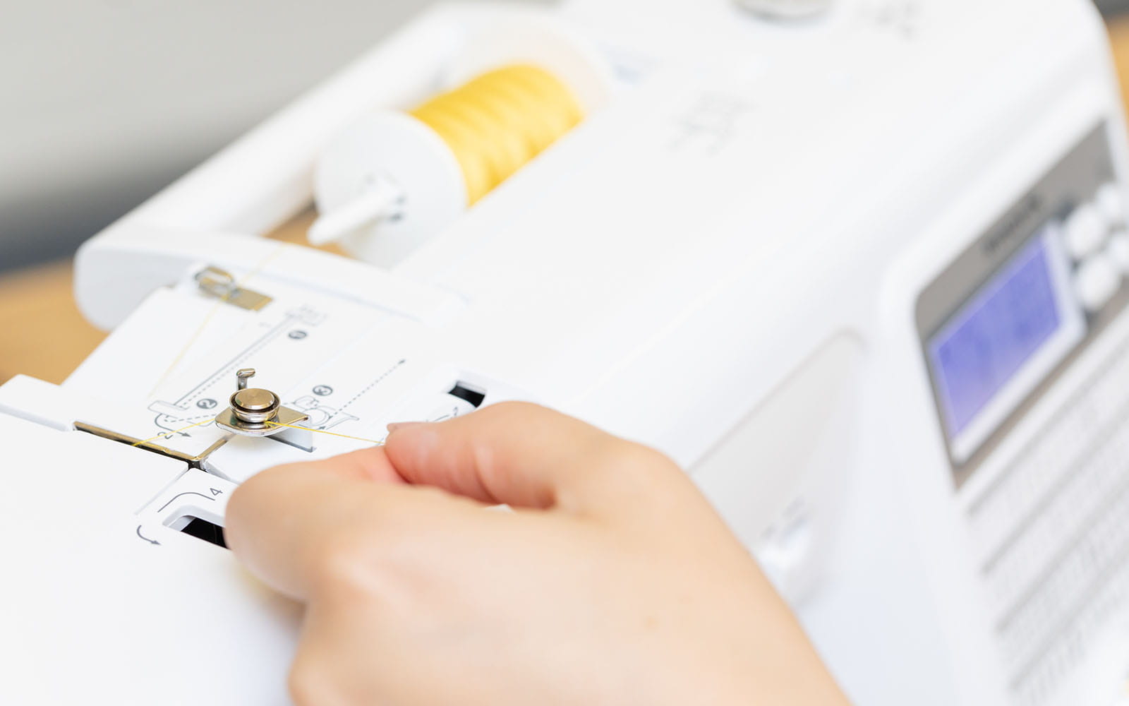 Threading yellow thread into Brother sewing machine