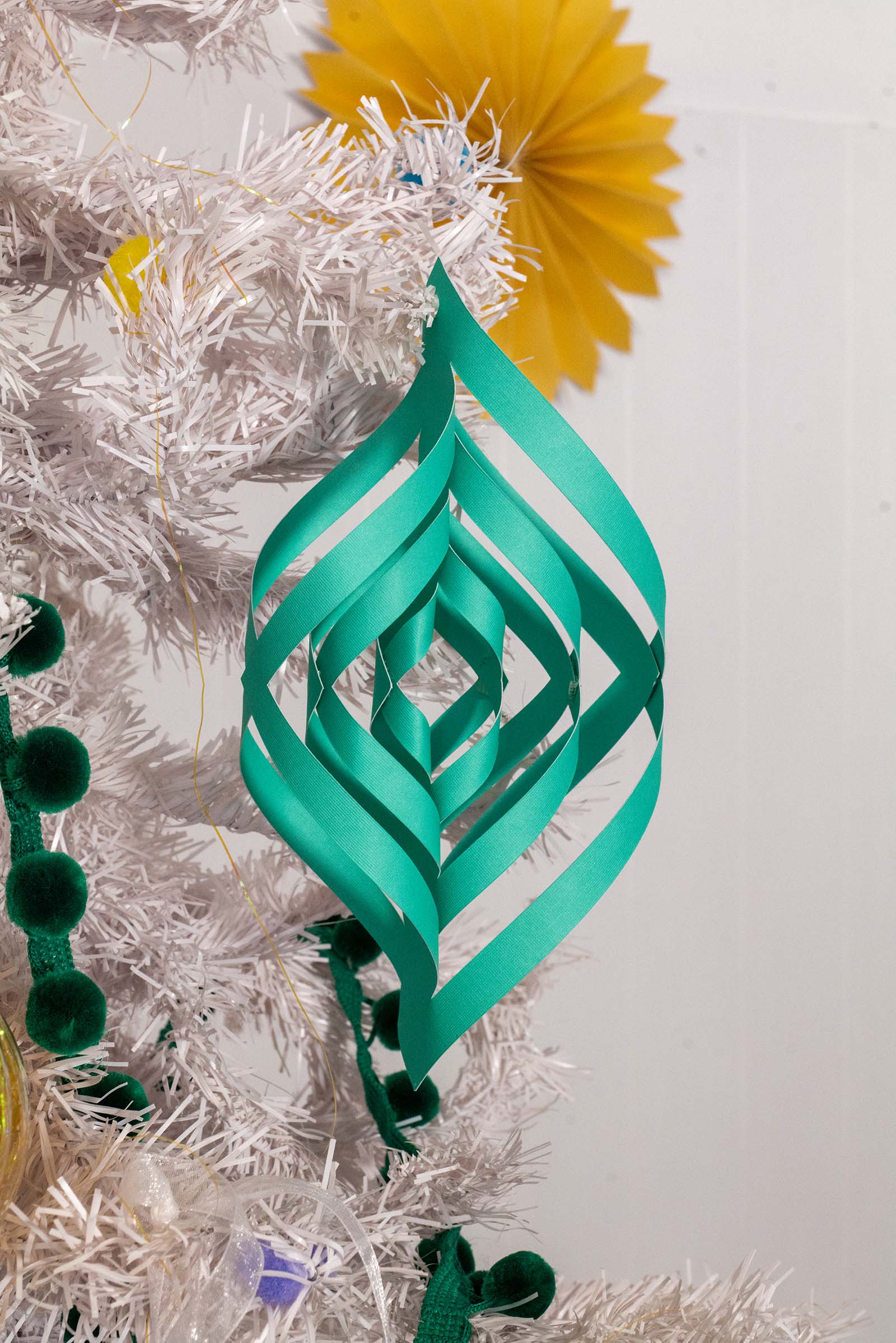 green 3D paper pendant hanging on christmas tree