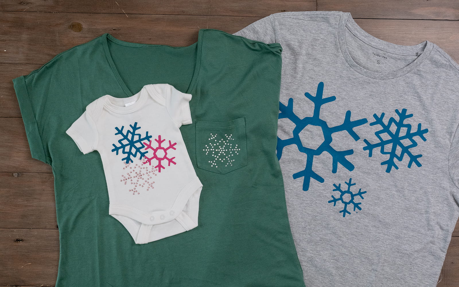 Three t-shirts with snowflake motifs